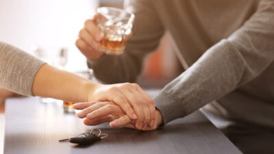 Woman preventing drunk man from taking car keys, closeup. Don't drink and drive concept